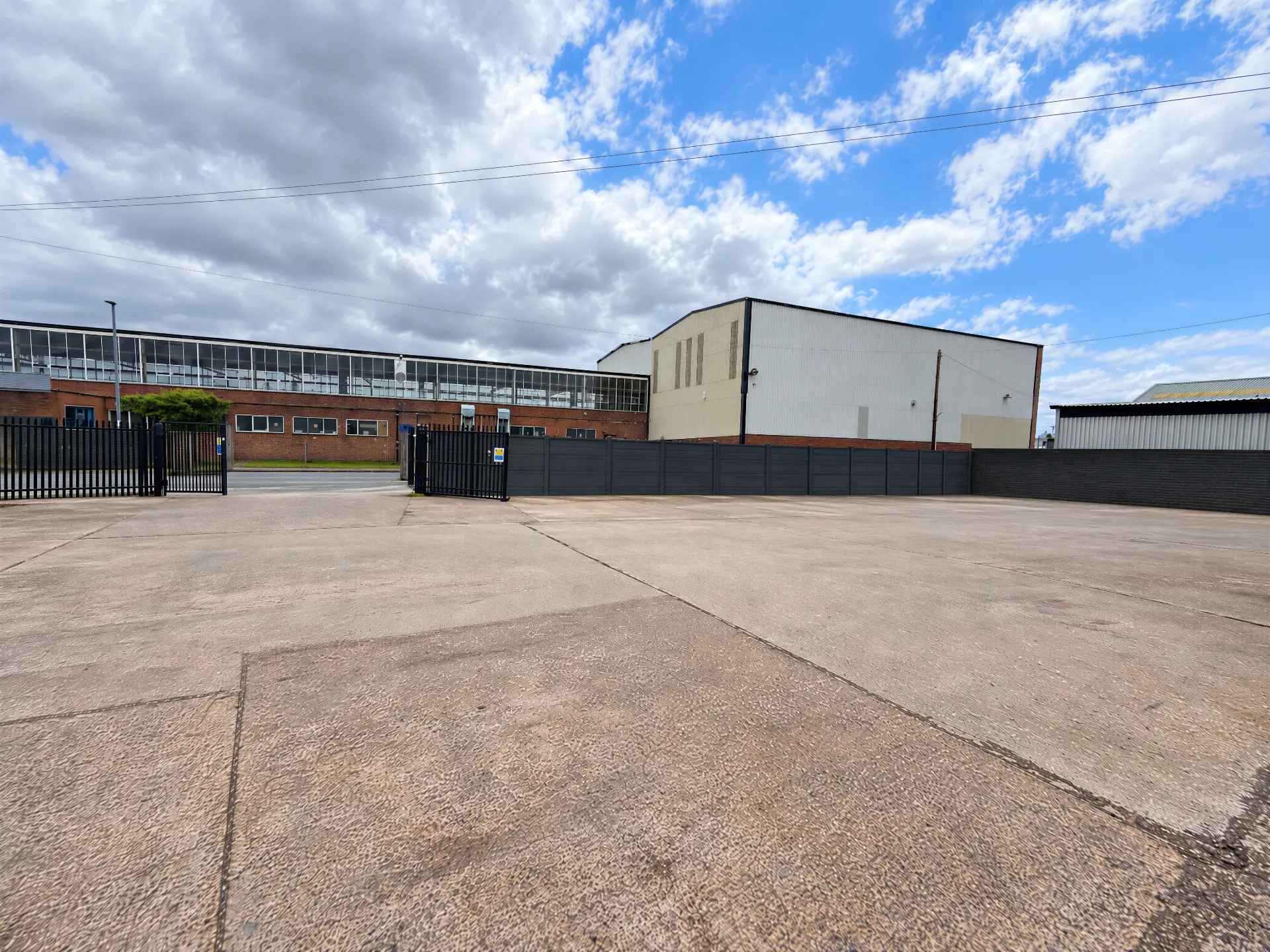 Secure concrete yard with new gates and fencing, accessed from Coldfield Drive
