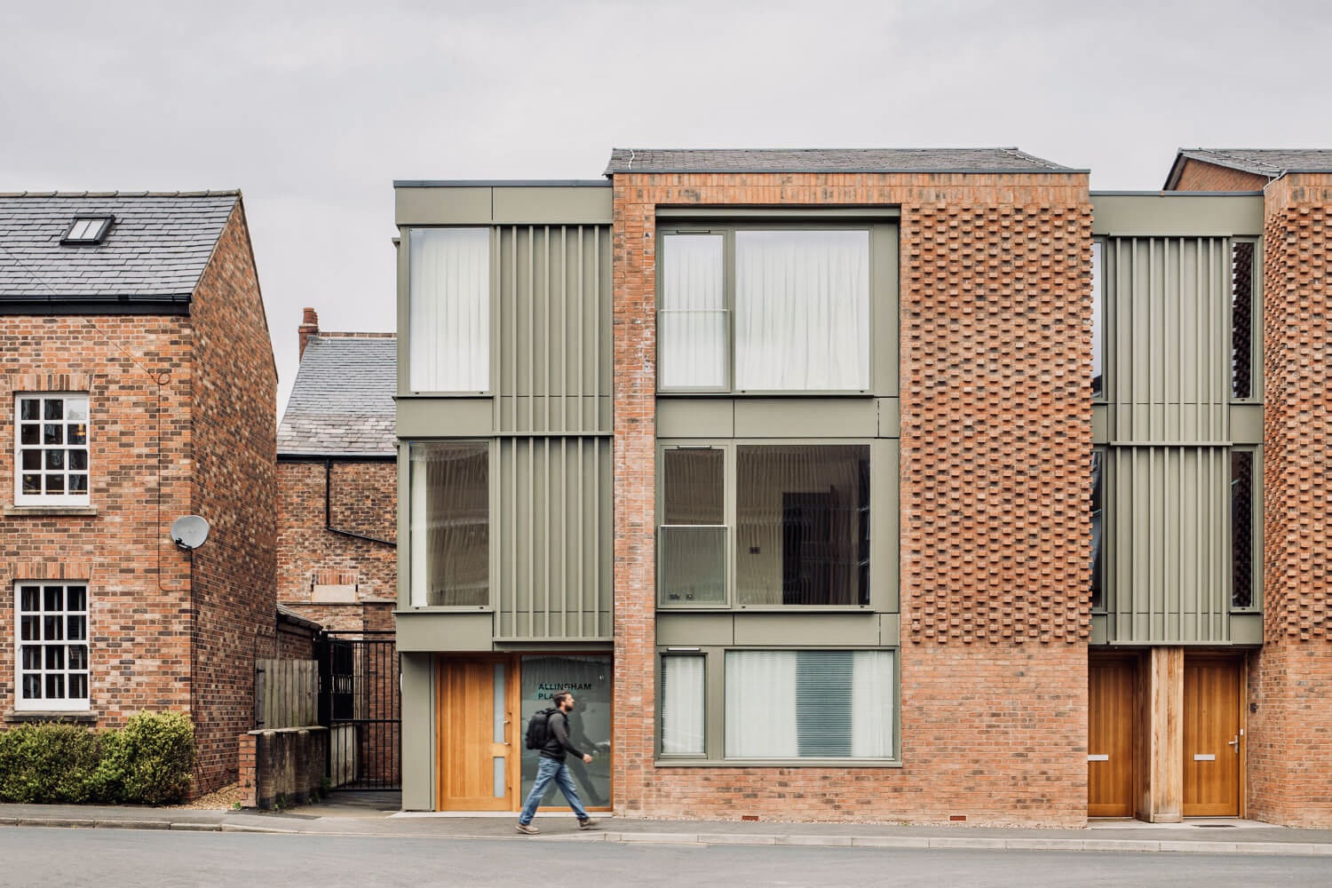 New Street, Altrincham: new homes with brick and green-clad frontages and timber entrance doors