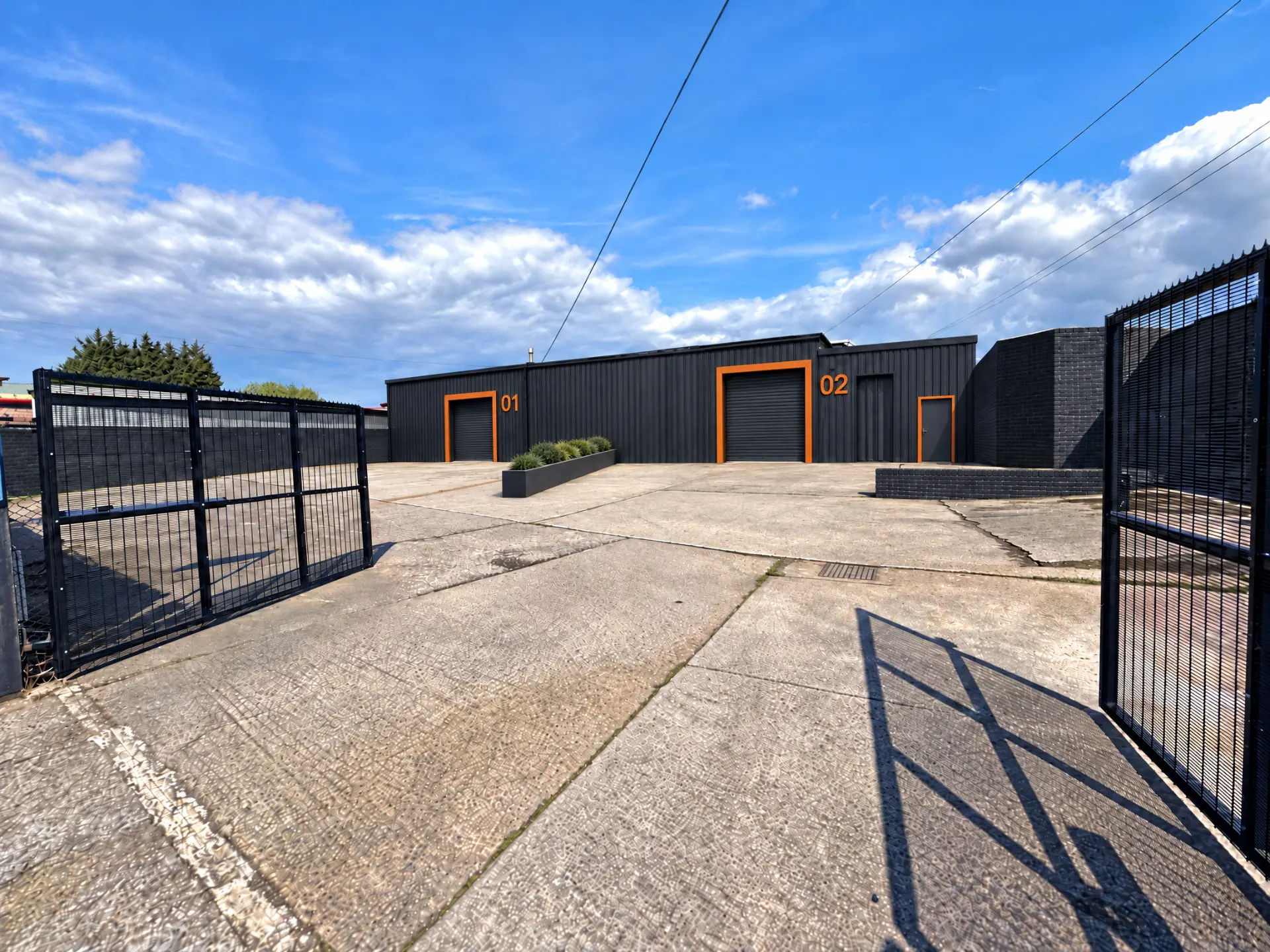 Proposed front elevation to Southmoor Road, with roller shutter doors and unit numbering