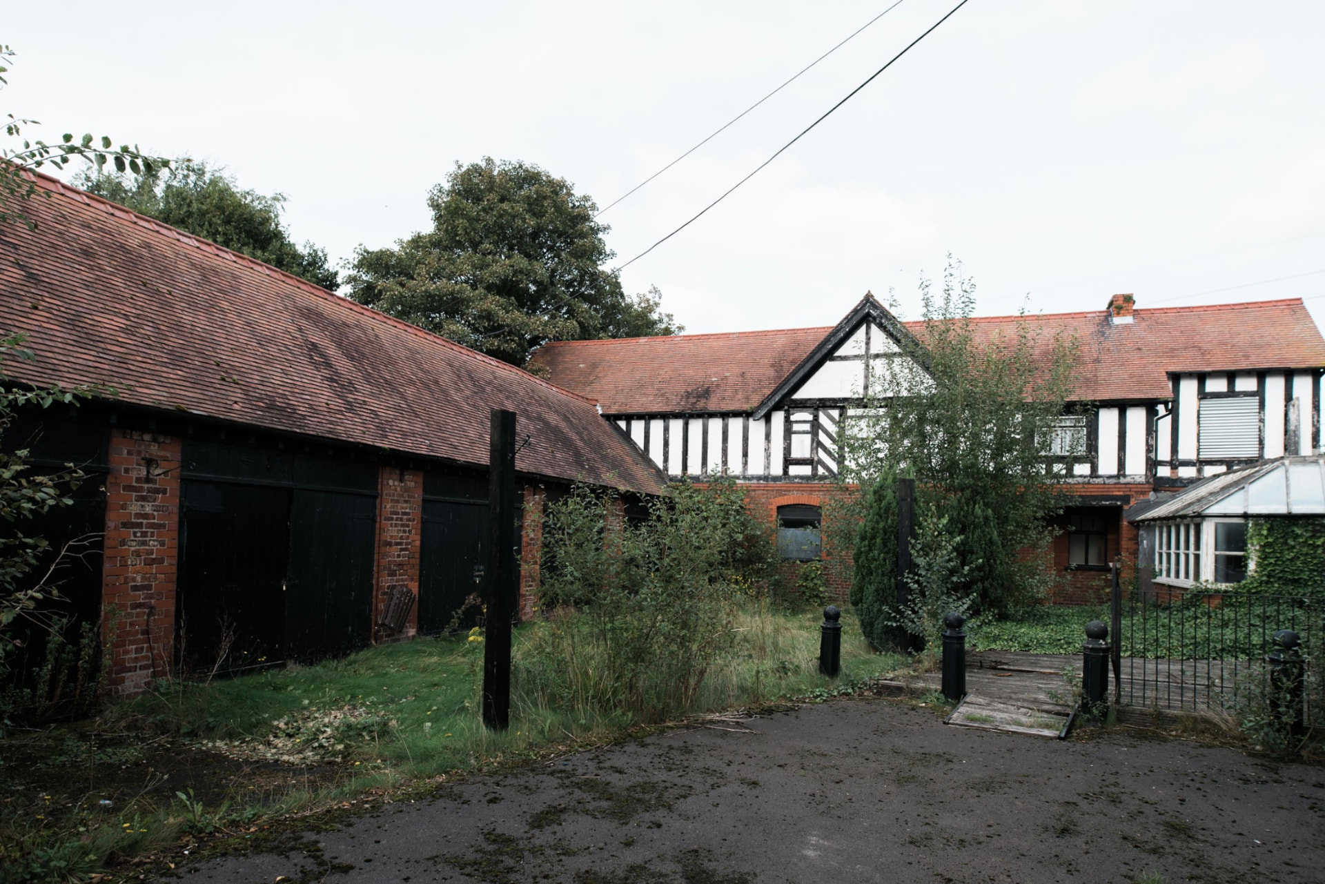 Derelict Stamford Arms pub and overgrown courtyard before restoration